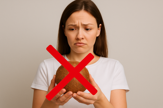 Woman holding a coconut with a red X symbolizing the risks of using coconut oil as personal lubricant.
