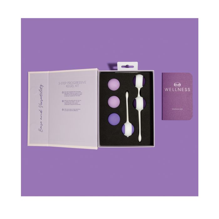 All the weighted Kegel balls and guidebook displayed together for a full view of the kit.