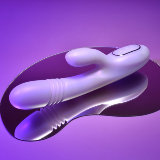 Close-up of main shaft of the Playboy-Bumping Bunny with 10 vibration and thrusting modes resting on purple backgrund.