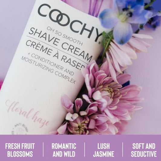 COOCHY Floral Haze Shave Cream 7.2 oz lifestyle image surrounded by fresh flowers highlighting its floral fragrance with fruit blossoms, jasmine, and soft romantic notes.