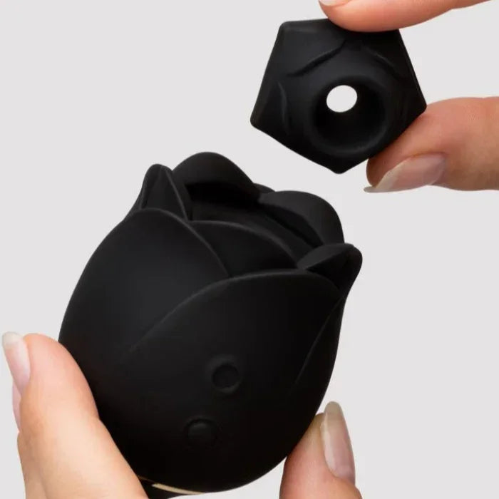 Hands gently removing the suction cap from Fifty Shades of Grey Dark Blushing Rose clitoral suction stimulator, demonstrting how easy it is to clean