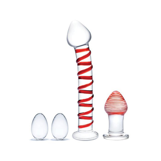 Four-piece Mr. Swirly glass sex toy set showing two red swirled Kegel balls, curved red swirled dildo, and tapered butt plug arranged on white background