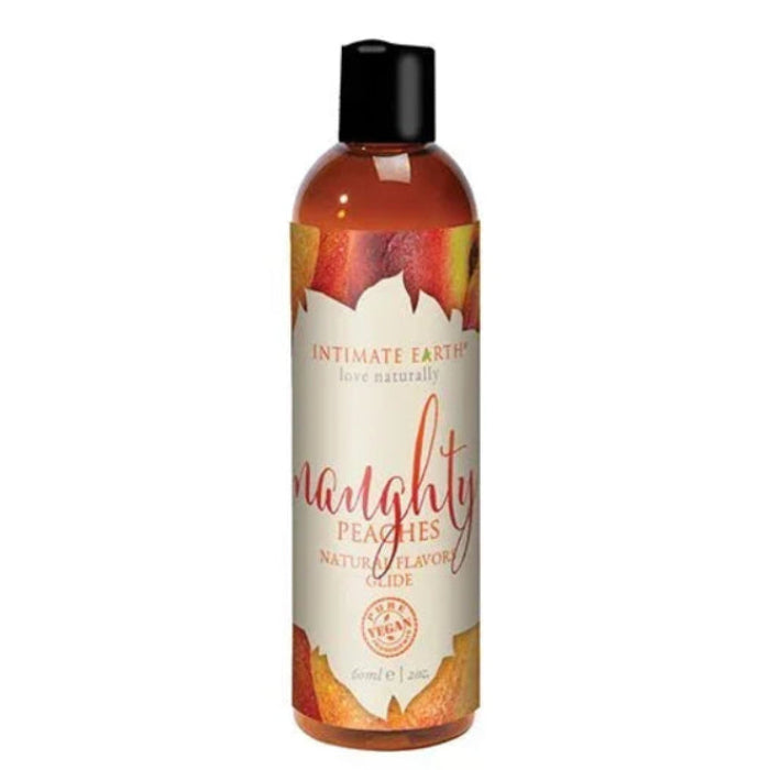 Intimate Earth Naughty Peaches Natural Flavors Glide bottle with soft peach-toned label featuring peach imagery; vegan, edible, pH balanced, water-based lubricant gentle on sensitive skin and safe for use on all erogenous zones; 2 oz travel size.