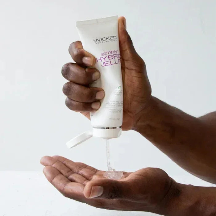 Man squeezing Wicked Simply Hybrid Jelle Lubricant into his palm demonstrating smooth gel texture and easy application.