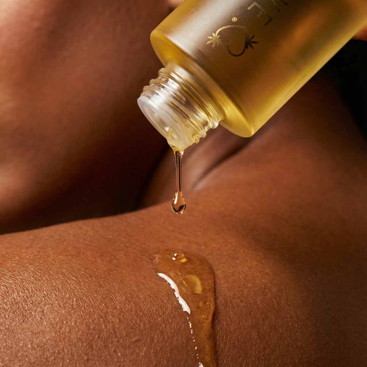 HighOnLove Strawberries & Champagne Massage Oil applied to skin for moisturizing body care and massage