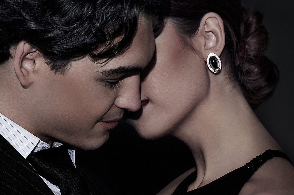 Romantic close-up of a couple in formal attire leaning in intimately, symbolizing attraction, chemistry, and pheromones on Valentine’s Day.