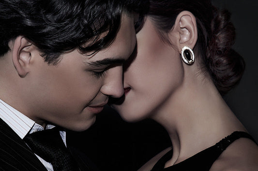 Romantic close-up of a couple in formal attire leaning in intimately, symbolizing attraction, chemistry, and pheromones on Valentine’s Day.