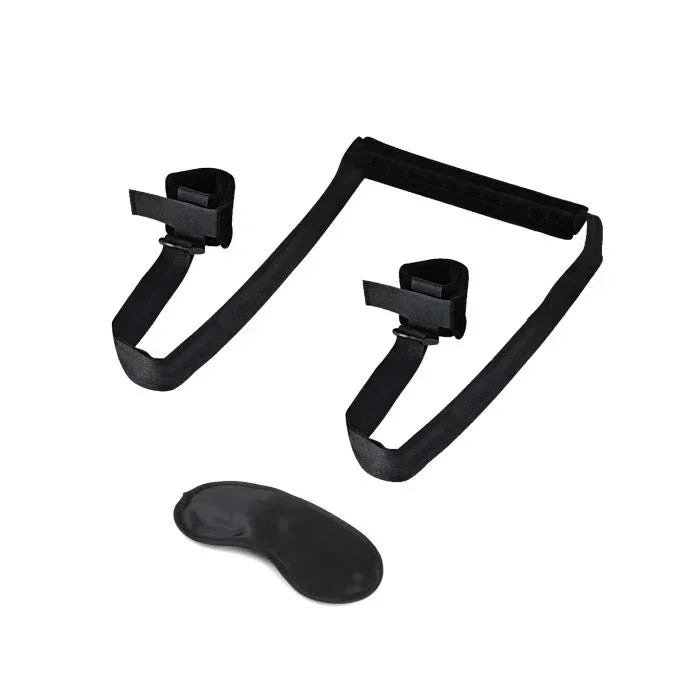 Adjustable position spreader strap laid out flat next to complimentary blindfold; showing padded neck support, adjustable straps, and attached ankle cuffs designed to lift and hold the legs during sex.