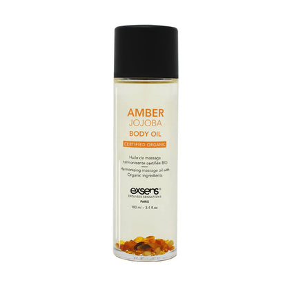 Exsens Amber Jojoba Crystal Body Oil pictured with amber stones, designed for confidence and creativity