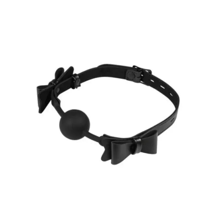 Sincerely Sportsheets Bow Tie Ball Gag made from vegan leather, showing the bow detail, adjustable strap, and smooth 1.65 inch ball laid out on a flat surface.