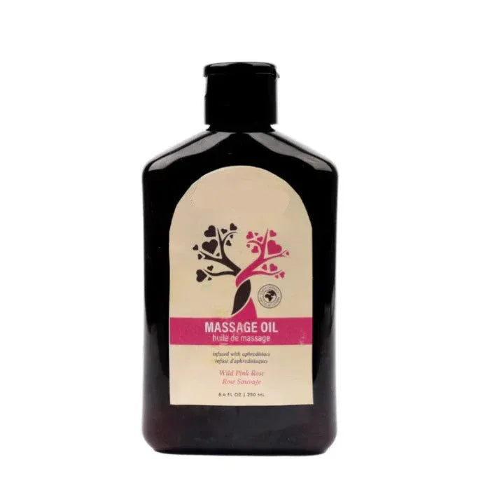 Front view of At Night Aphrodisiac Massage Oil bottle in Wild Pink Rose scent, showing pink rose label and product name on the front.