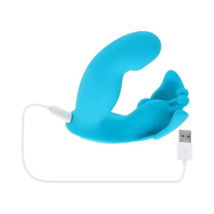 Spread Your Wings butterfly vibrator connected to a USB charging cable, showing the rechargeable design and charging port.