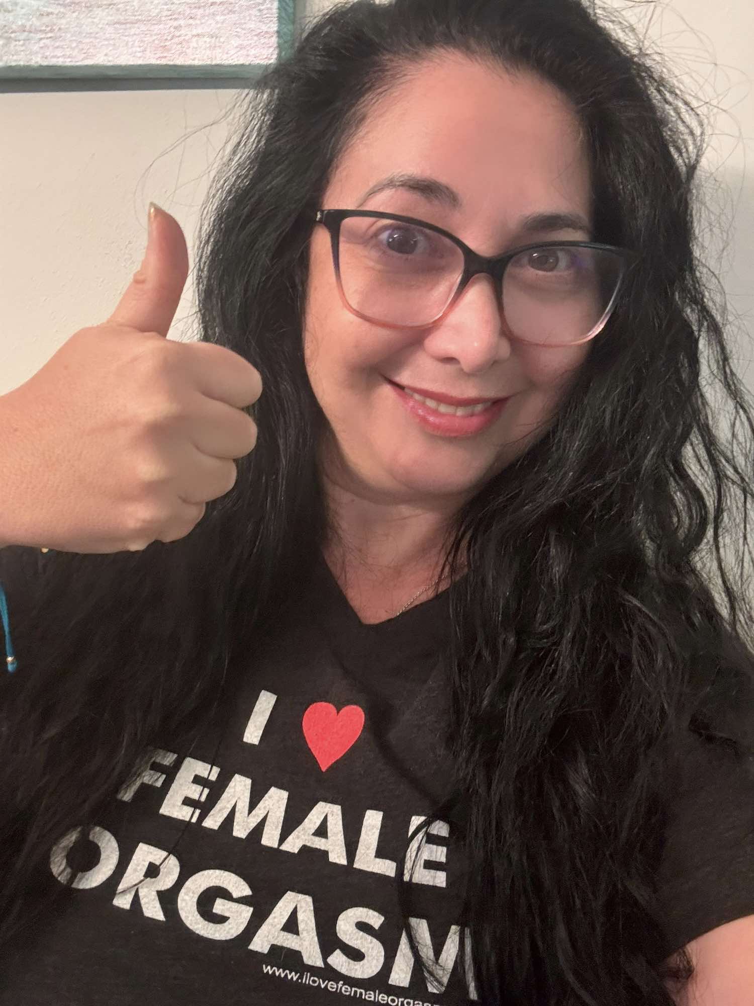 Linda Koontz, founder and CEO of The Flirtation Station, sexual wellness expert, wearing I love Female Orgasm t-shirt.