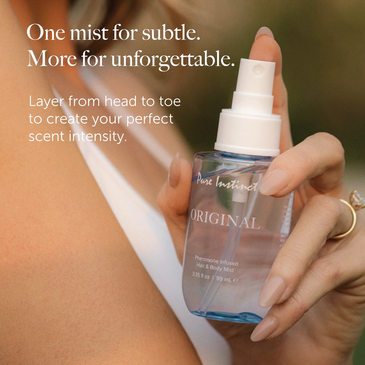 Woman holding True Blue pheromone fragrance mist layering scents