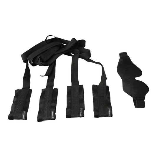 Adjustable black bondage restraints for wrists and ankles in beginner’s kit on a white background