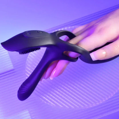 Close-up of The 3 Way vibrating cock ring worn on woman's hand showing velvet-smooth black silicone texture and the optional way to use. 