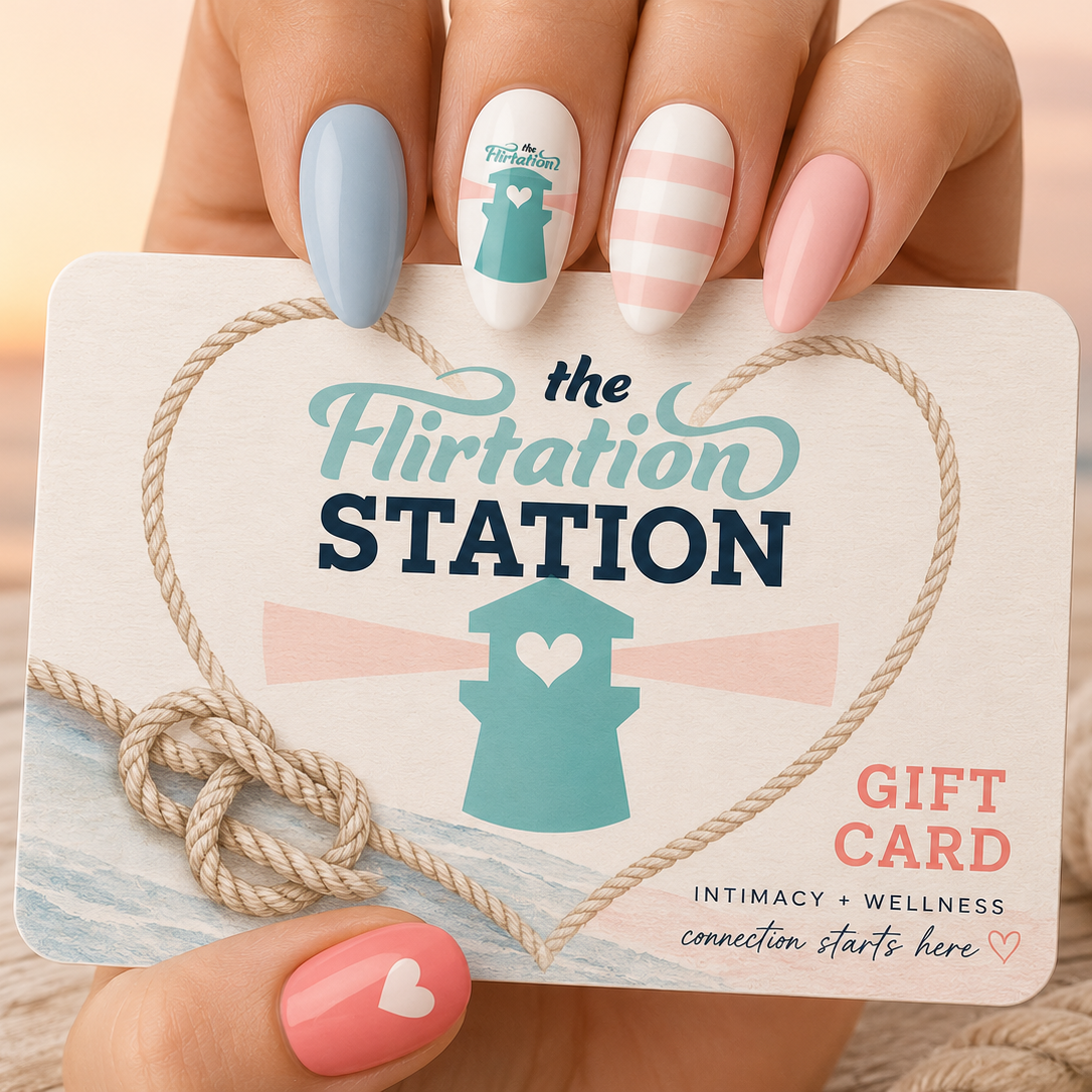 Gift card from 'The Flirtation Station' held by a hand with pastel nail polish.