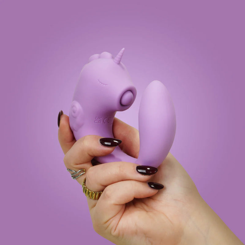 Unihorn C-Horse Marina Lilac dual motor ladies vibrator held in hand showing flexible silicone tail
