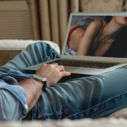 man about to use the Lovense Gush 2 Handsfree Masturbator with his girlfriend who is on his laptop