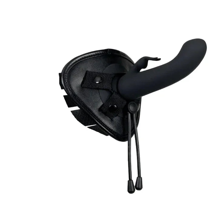 Close up view of Evolved Heavenly Harness curved G-spot rabbit silicone sleeve attached to vibrating base in the harness with adjustable black straps