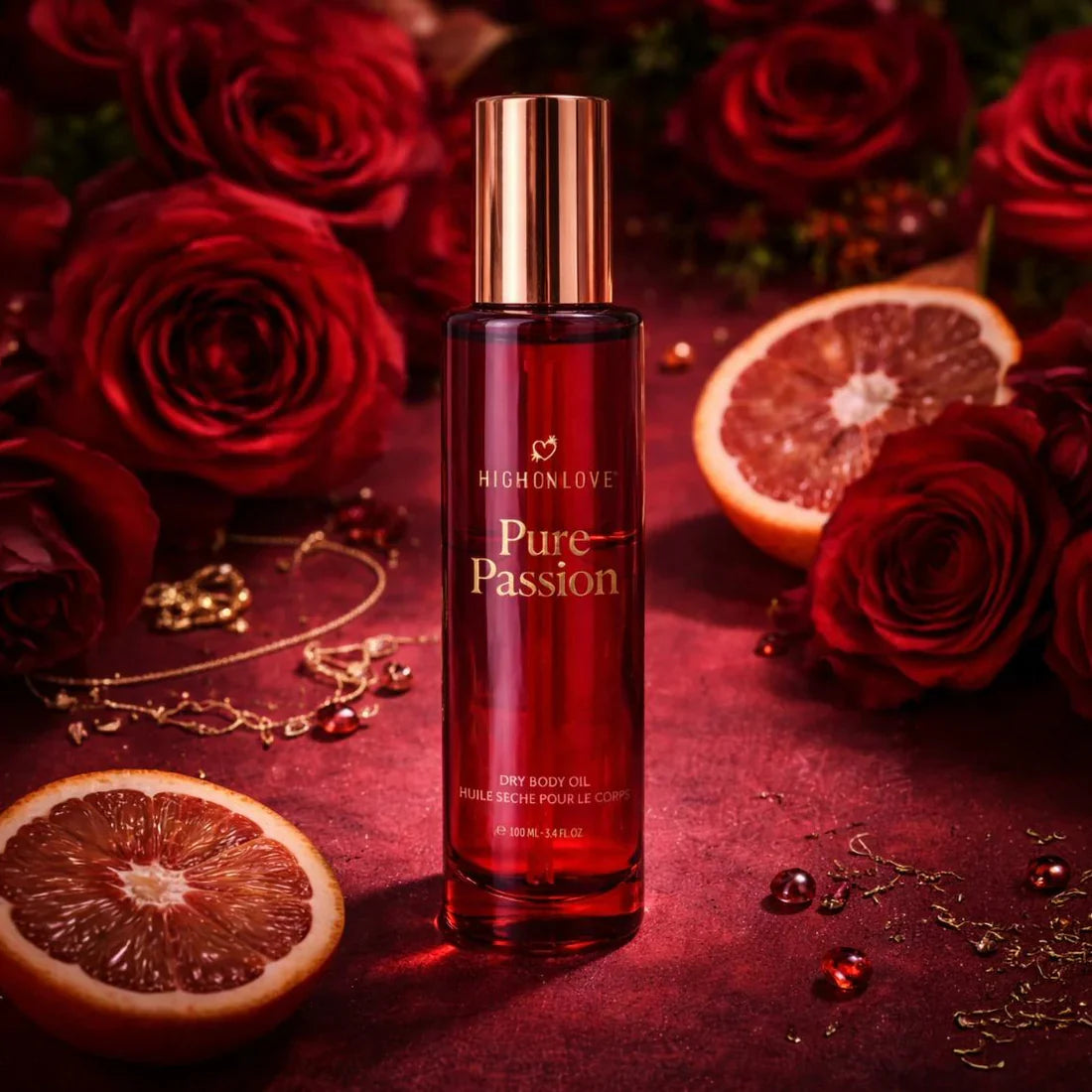 HighOnLove Pure Passion Dry Body Oil surrounded by roses and citrus for a luxurious fragrance experience