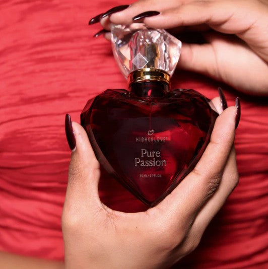 Woman holding HighOnLove Pure Passion Eau de Parfum 50 mL luxury perfume bottle