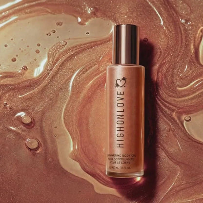 HighOnLove Shimmering Body Oil bottle surrounded by luminous bronze shimmer