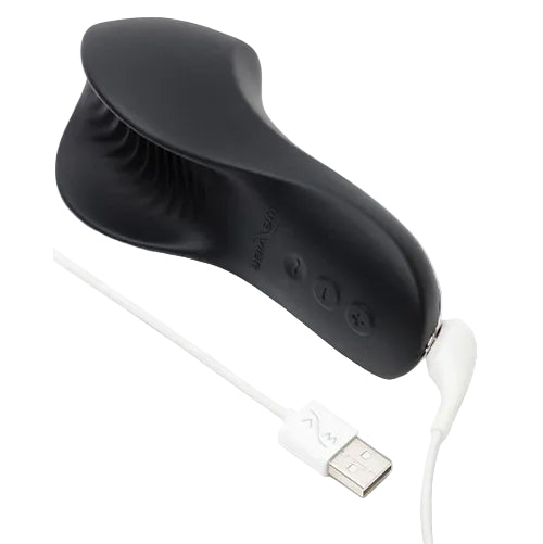 We-Vibe Shared Touch black vibrator connected to its USB charging cable, showing the rechargeable design and control buttons.