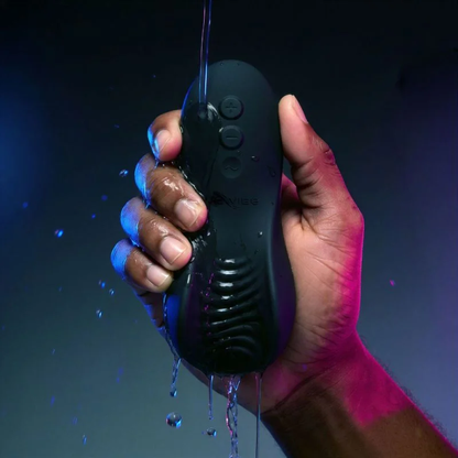 Black We-Vibe Shared Touch waterproof couples vibrator held under running water, showing its textured surface and controls.